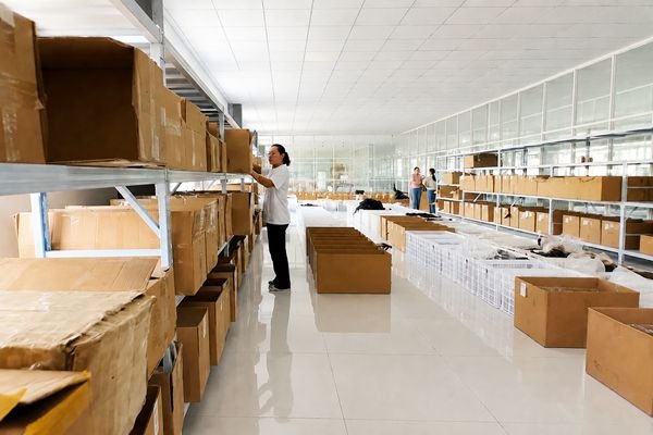 Boxes of finished hair extensions being prepared for shipping in a clean, organized warehouse