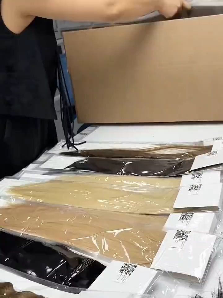 Boxes of hair extensions neatly packed and labeled for shipping in a clean warehouse environment.